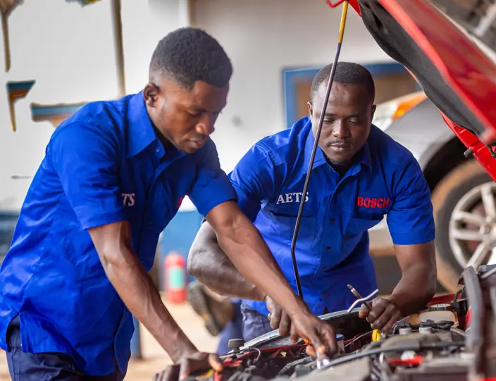 Technicians servicing an engine bay