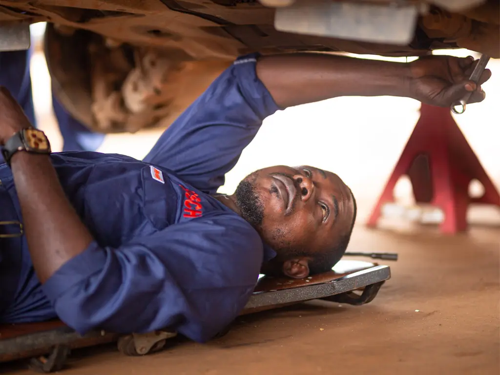 Technician working underneath a vehicle
